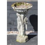 A reconstituted stone figural bird bath, the circular bowl upon an integrated 'Three muses'