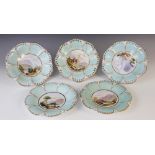 A Victorian topographical dessert service in the manner of Coalport, comprising; three tripod