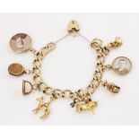A 9ct gold curb-link charm bracelet with a heart-shaped padlock fastener, 18cm long, suspending an