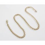 A 9ct gold curb-link chain, with lobster claw and loop fastener, 36cm long, weight 23.2gms