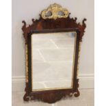 A George III mahogany fret work wall mirror, the giltwood basket crest flanked by 'C' scrolls, above