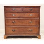 A George III oak and mahogany cross banded chest of drawers, formed from two short and three long