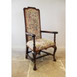 A Queen Anne style chair, 19th century, the oak frame enclosing an upholstered high back above a