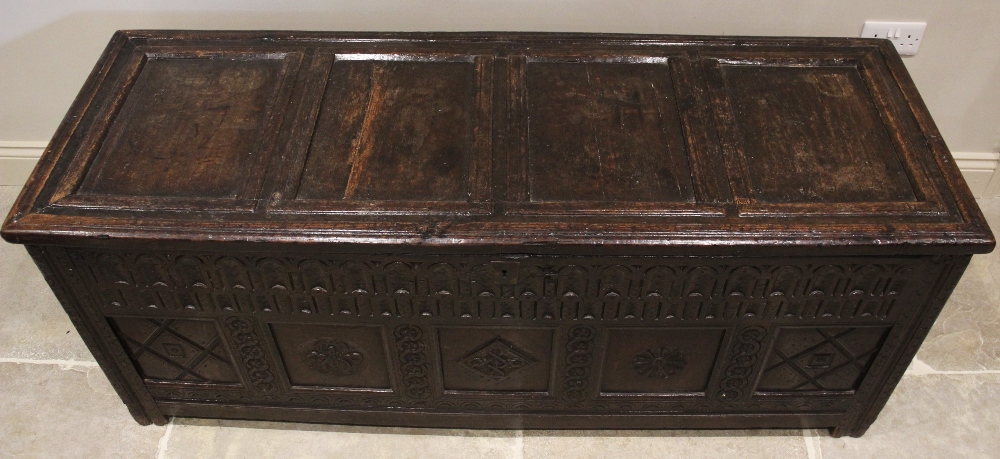A 17th century oak coffer, the hinged cover with four invert moulded panels above a double nulled - Image 2 of 3