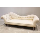 A Victorian button back chaise longue, the shaped padded back extending to padded scrolled arms,