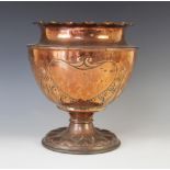 An Arts & Crafts copper vase in the manner of J & S Sankey, raised upon a pedestal foot with heart