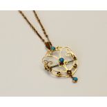 An Edwardian turquoise and seed pearl set pendant/brooch, the unmarked yellow metal open work
