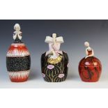 Three French Art Deco bonbonnieres or jars and covers by Robj, early 20th century, each modelled