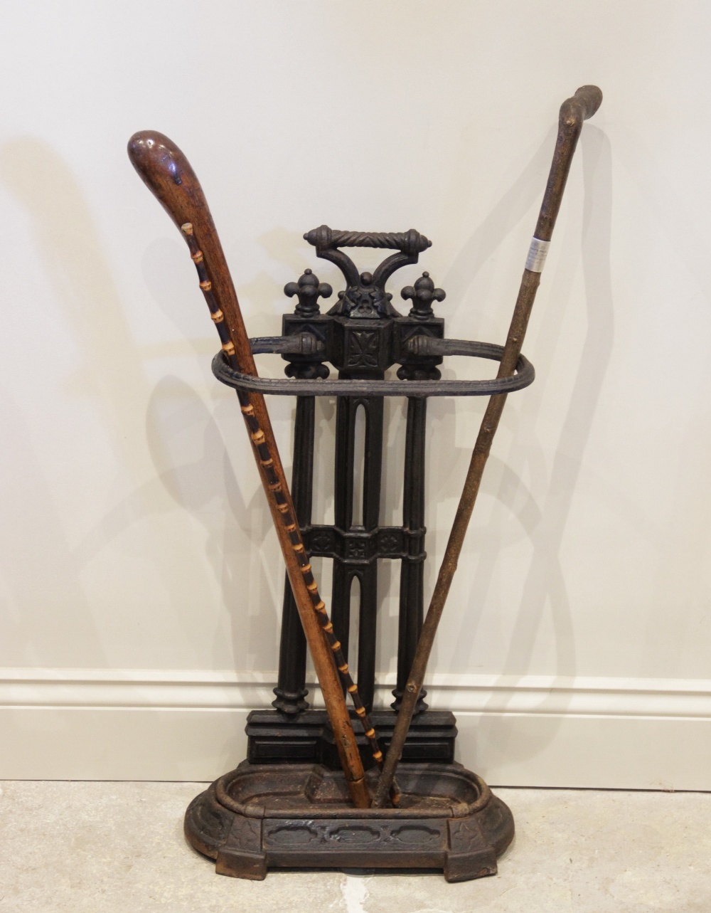 A Victorian cast iron stick stand, of architectural form, the uprights formed as twin cluster