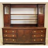 A George III oak and mahogany cross banded dresser, the inverted breakfront rack with three open
