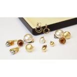 A pair of citrine set 9ct gold earrings, each comprising a central round mixed cut citrine measuring