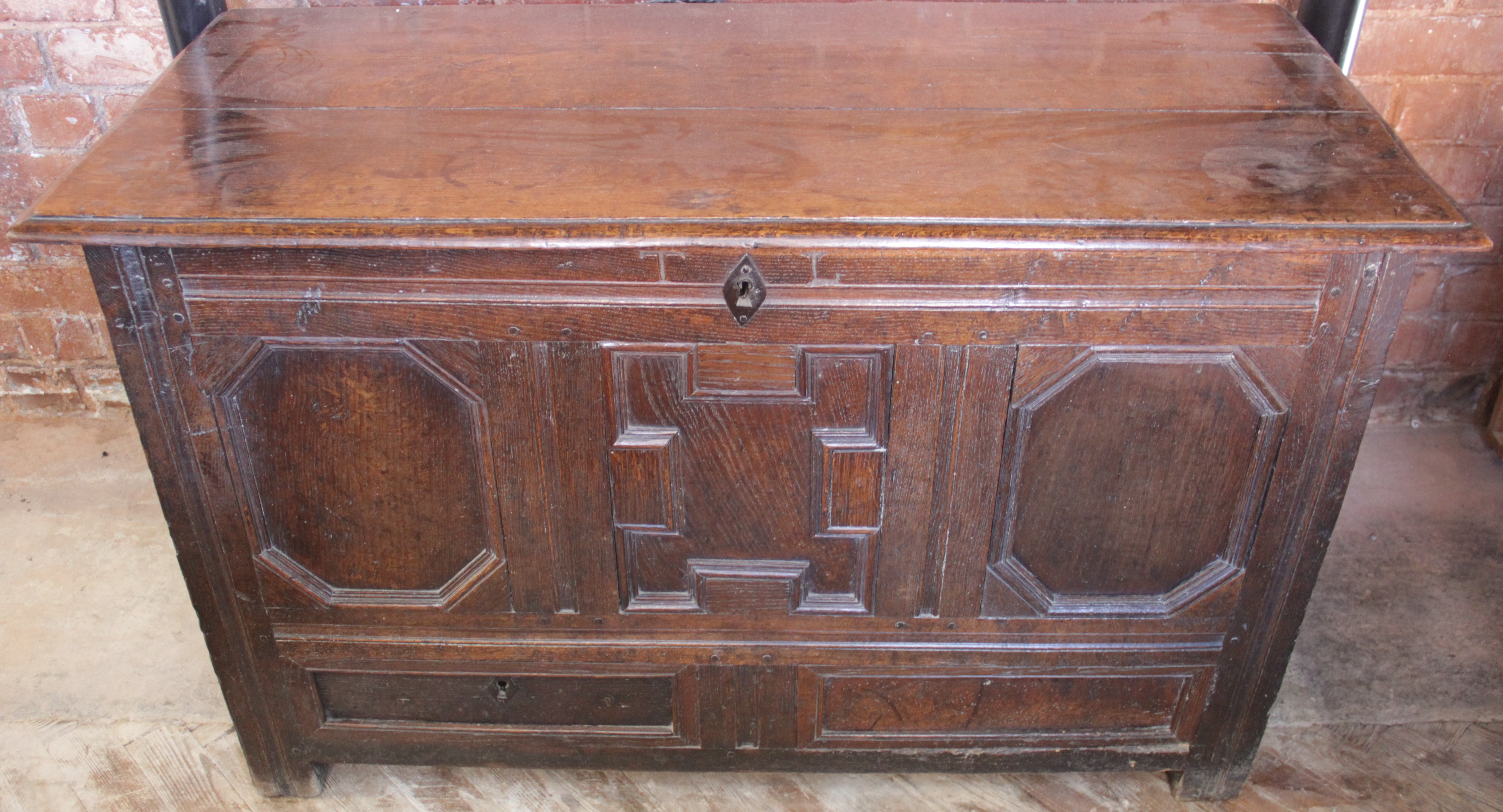 An 18th century oak coffer, with fielded panel front