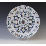 A Delft ware charger, 18th century, the polychrome tin glazed earthenware charger of circular