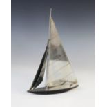 An Art Deco chromed metal model of a yacht in full sail, the chrome deck set to a matt black