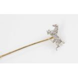 An early 20th century diamond and ruby horse stick pin, the horse modelled in gallop and set with