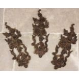 Three carved wooden architectural panels modelled as garland hanging floral and foliate bouquets,