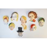 A collection of eight Art Deco miniature wall masks, by makers including Cope & Co, five modelled as