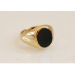 A 9ct bloodstone signet ring, the central oval bloodstone panel (measuring 11mm x 9mm), rub-over set