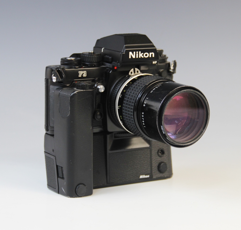 A Nikon F3 35mm SLR camera serial number 1887470, mid 20th century, fitted with a Nikkor 135mm 1: