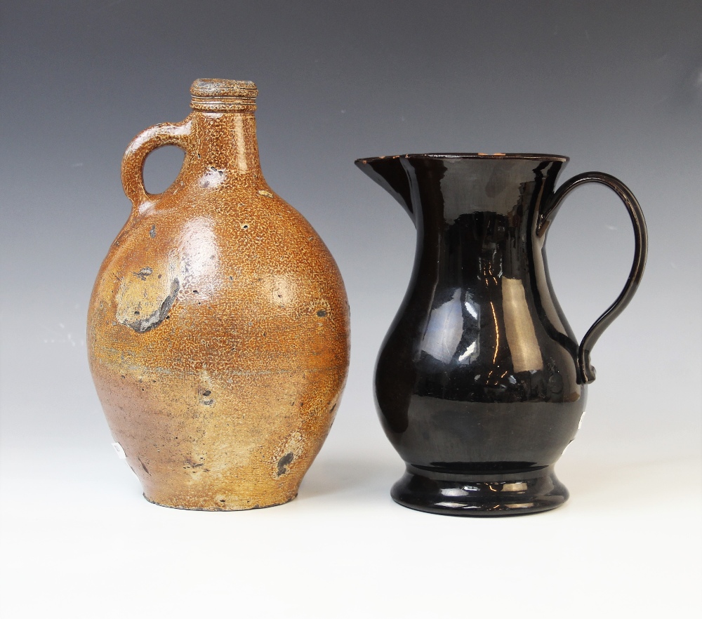 A black glazed Jackfield type water jug, late 18th century, of baluster form with applied loop