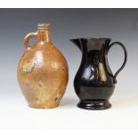 A black glazed Jackfield type water jug, late 18th century, of baluster form with applied loop