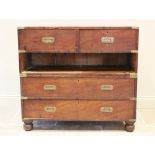 A mid 19th century mahogany campaign chest, the twin sectional chest applied with brass corner