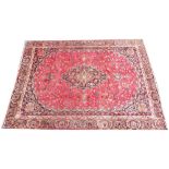 A large rich red multi coloured field Persian mashed carpet, with a traditional floral design, 370cm