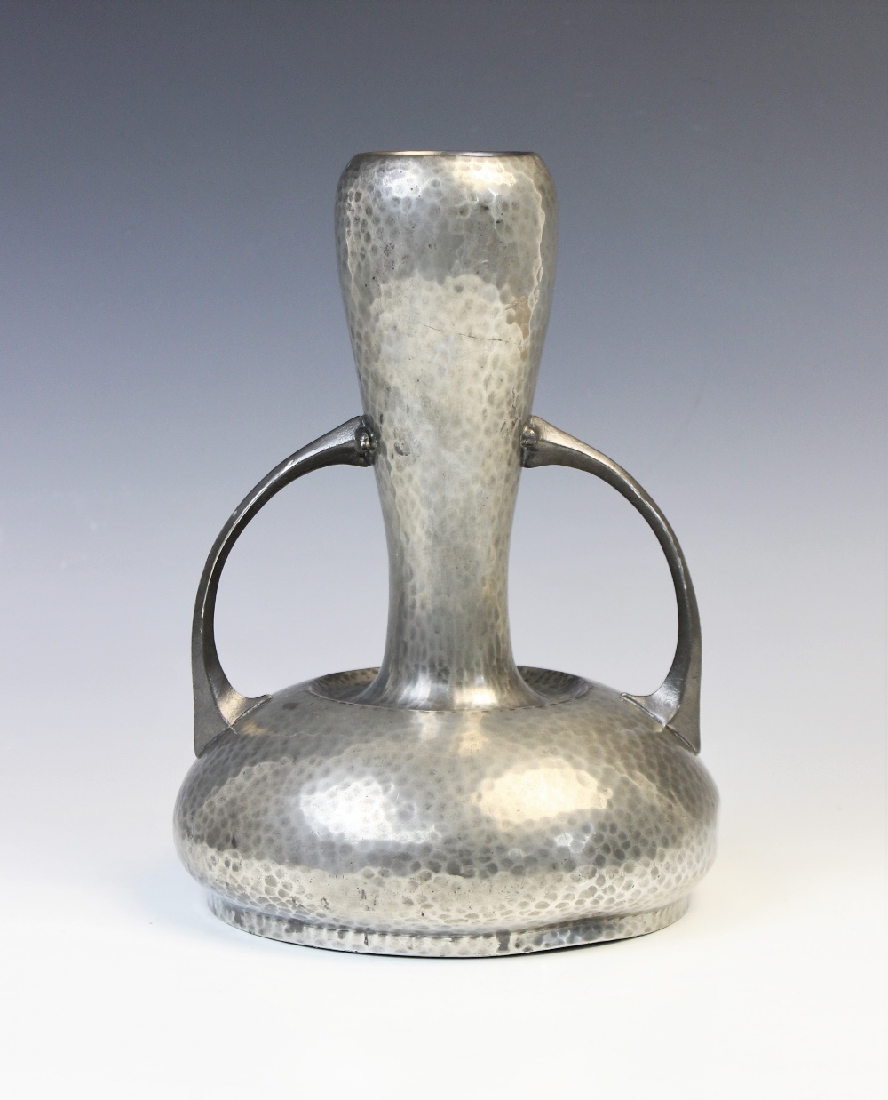 An Art Nouveau pewter vase from the 'Homeland' range by Walker & Co, the hammered body of gourd form