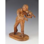 An early 20th century Hungarian figural carving of a Violinist, dated '1934' Budapest and signed '
