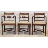 A pair of Regency mahogany carver chairs, each with a concave rail back extending to reeded down