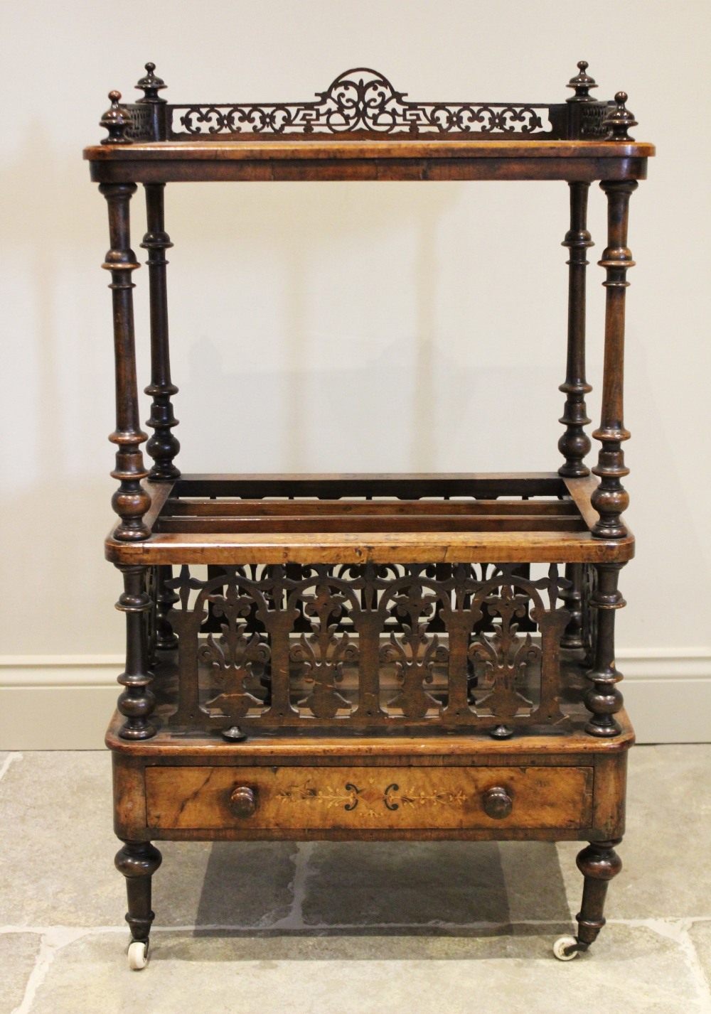 A Victorian burr walnut etagere Canterbury, the quarter veneered rectangular top with an open work