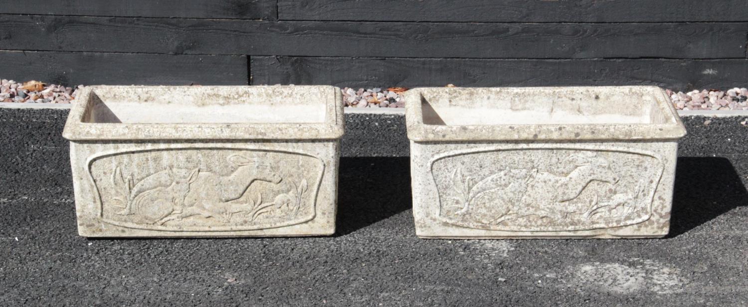 A pair of Yellowstone rectangular stone planters, each cast in relief with deer figures to the