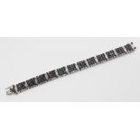 A diamond and sapphire bracelet, comprising twelve panels each set with sixteen round mixed cut