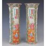 A pair of Chinese Canton vases, 19th century, each of cylindrical sleeve form and decorated in