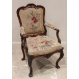 A Louis XV style walnut fauteuil, late 19th century, the foliate tapestry padded back within a shell