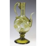 A German green glass historismus ewer, 20th century, with wheel shaped body supported on a knopped