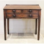 A George III oak clerks desk, the three quarter galleried top above a cross banded hinged slope,