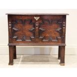 A 17th century style oak coffer bach, late 19th century, the rectangular moulded top above a pair of