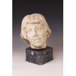 An Art Deco marble sculpture of a female head, early 20th century, set above a grey marble plinth,