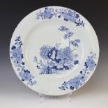 A large Chinese porcelain charger, 18th century, of circular form and decorated with floral