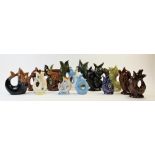 A collection of novelty glug jugs, to include dolphin's mask, mermaid and polychrome examples, by