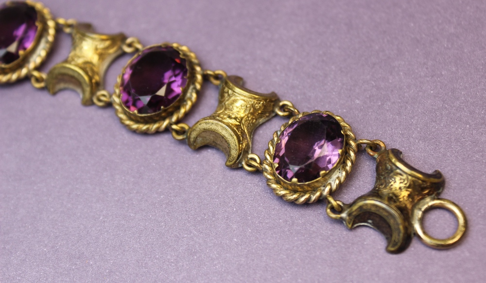 A Victorian style paste set bracelet, comprising four oval mixed cut purple paste, each measuring - Image 3 of 3