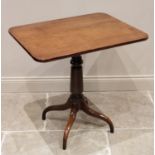 An early 19th century mahogany tripod table, the rectangular top with rounded front corners,