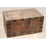 A 19th century pine trunk, applied with metal corner brackets, iron clasp and side swing handles,