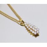 A diamond teardrop pendant, comprising eighteen round brilliant cut diamonds, (estimated diamond