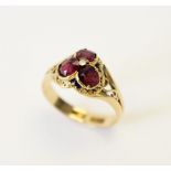 A Victorian garnet and enamel 18ct gold ring, the trefoil shaped head set with three oval old cut