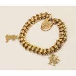 An early 20th century yellow metal charm bracelet, double curb link chain with engraved rollerball
