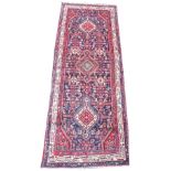 A rich blue ground full pile Iranian runner, with medallion design, 303cm x 110cm