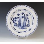 A Delft ware charger, 18th century, the tin glazed earthenware charger of circular form, the central