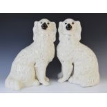 A large pair of Victorian Staffordshire glass eyed spaniels, 19th century, the gilt highlighted